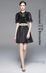 Detail of lace bodice with sequins and elegant pearl belt on high waist black dress