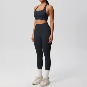 Side view of black yoga set featuring high-waisted leggings and sports bra on model