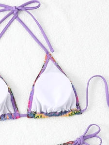 Close-up of purple triangle bikini top with colorful braided trim and halter ties