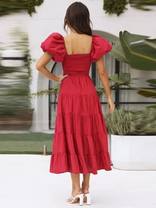 Back view of a red off-shoulder puff sleeve maxi dress with tiered hem and smocked back