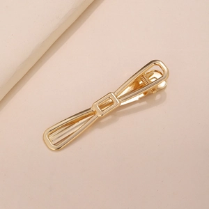Detailed top view of a gold-plated heart-shaped metal hair clip with a smooth surface