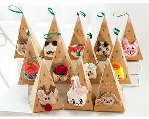 Detailed view of cartoon animal coral fleece socks in triangular Kraft gift boxes