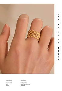 Detailed view of a gold double-layer geometric cutout ring on a finger with retro style