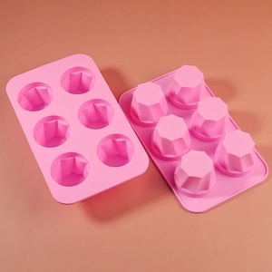 Detail of 6-cavity pink silicone mold featuring geometric diamond shapes for DIY baking