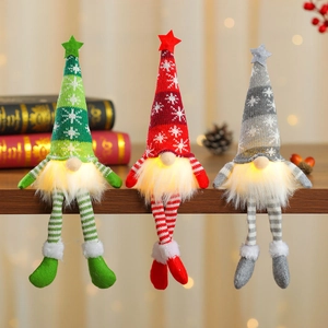 Three glowing Christmas gnomes with LED beards and snowflake knit hats on wood shelf