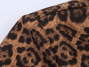 Macro shot of faux suede leopard print fabric showing seam details of the trench coat