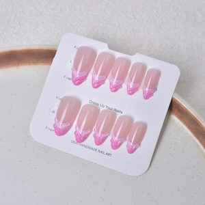 Pink gradient press-on nails with 3D flame texture displayed on a white card tray