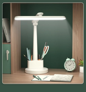 Foldable LED desk lamp with pen holder base on a wooden table for study or dormitory