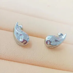 Detailed view of silver-tone teardrop earrings with a polished finish in a display box