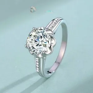 Macro view of sterling silver crown ring with six-prong moissanite and side diamond pavé