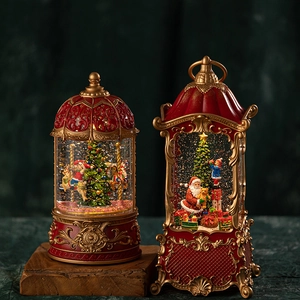 Christmas musical snow globe and lantern with Santa and carousel in red gold finish