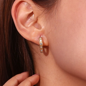 Elegant 18K gold plated stainless steel huggie earrings with square crystals on model