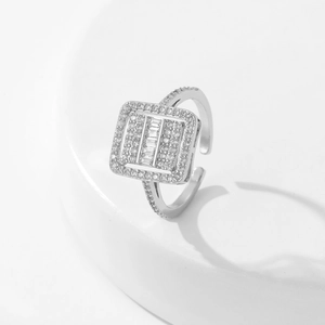 Macro detail of silver open ring featuring a square center set with cubic zirconia stones