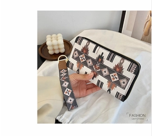 Ethnic geometric pattern long wallet with zip-around closure and matching wrist strap