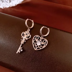 Asymmetric vintage heart and key hoop earrings with zircon stones in rose gold finish