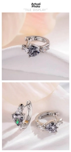 Macro detail of heart-shaped zircon earrings featuring silver metal and drop-shaped stones