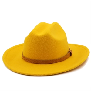 Detail of yellow wool fedora showing brown snake-patterned leather belt and metal buckle