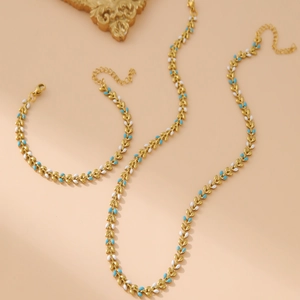 Golden stainless steel leaf necklace and bracelet set with blue and white enamel inlay