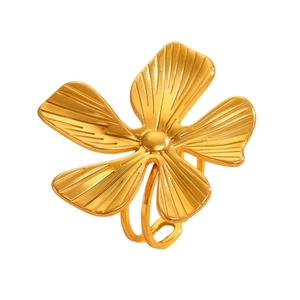 Detailed view of a gold flower ring featuring radial petal textures and dual ring bands