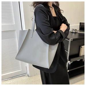 Lifestyle shot of large gray tote bag for women showing spacious interior and handles