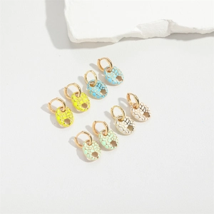 Flat lay of oval mosaic stud earrings in blue, yellow, white, and green with gold plating