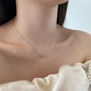 Close-up of S925 sterling silver necklace with a delicate pink heart-shaped stone pendant