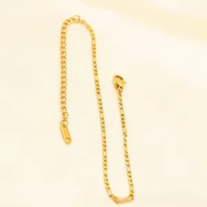 Detailed macro view of the gold plated Figaro chain anklet with a lobster clasp closure
