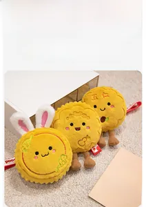 Close-up of plush mooncake rabbit keychain with red hanging string and embroidery