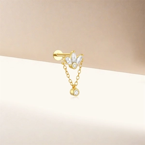 Detail of gold S925 silver stud featuring three leaves, chains, and cubic zirconia drop