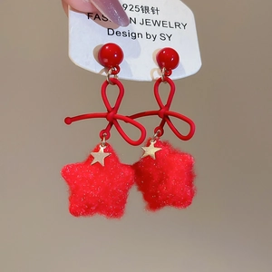 Detail of red flocked star earrings with bowknot and 925 silver needle studs