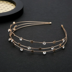 Détail d'un serre-tête triple en métal doré orné d'étoiles et de strass en cristal
