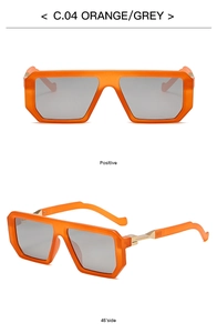 Detail view of orange square sunglasses with grey lenses and gold metal accents