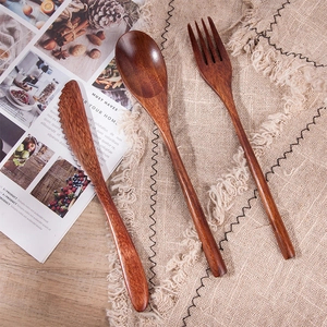 Japanese style nanmu wood cutlery set including knife, fork and spoon on burlap background