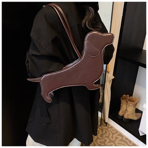 Fashionable brown dachshund-shaped shoulder bag worn as a creative underarm tote style