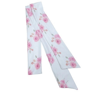 Detail view of the soft white fabric strap featuring an elegant pink rose floral pattern
