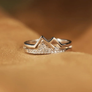 Detailed macro view of silver mountain-shaped ring with pavé zircon setting
