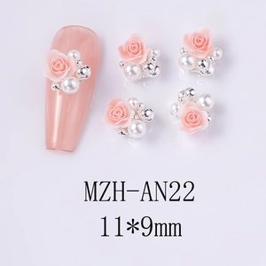Detailed view of pink resin rose nail charms with white pearls and silver beads