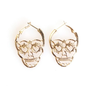 Vintage gold hollow skull earrings with heart eye details on a clean white background
