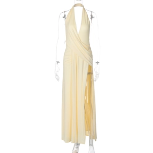 Detail view of light yellow halter dress with deep V-neck and high leg slit design