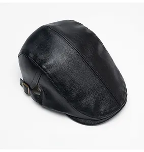 Close-up of black faux leather cap featuring lychee grain texture and side metal buckle