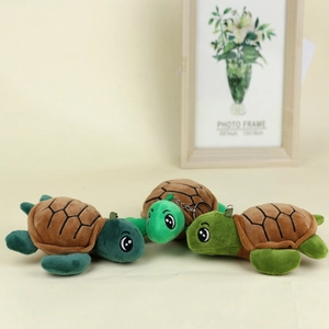 Plush turtle keychain set in three shades of green with brown shells and metal hooks