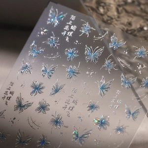 Holographic butterfly nail stickers with floral patterns on a semi-transparent base