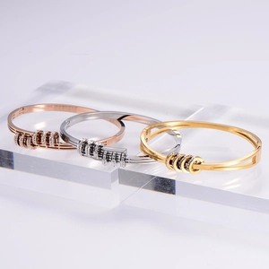 Three-tone titanium steel bangles in gold, silver and rose gold with pavé crystals