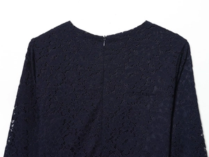 Detail of navy blue lace midi dress featuring a hidden zipper on the back neckline