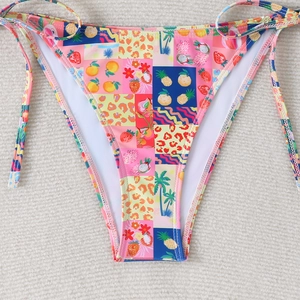 Detail of colorful bikini bottom with tropical fruit print and side tie strings