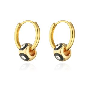 Detailed view of gold plated hoop earrings featuring black and white enamel evil eye charms