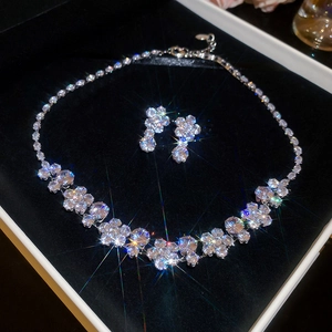 Close-up of zircon flower jewelry set in black velvet box with luxury light starburst effect