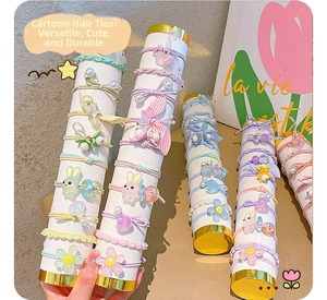 Detailed close-up of macaron colored elastic hair ties with cute cartoon resin charms