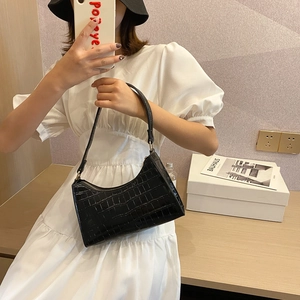 Classic black crocodile pattern underarm bag with zipper closure and ergonomic handle