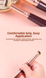 Detail of rose gold ferrule and fine synthetic bristles on professional makeup brush